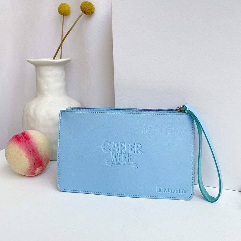 Elegant zippered leather clutch bag properly stored in upright position